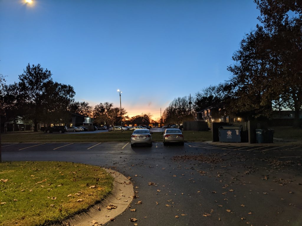 Sun setting over a Winfield Village parking lot