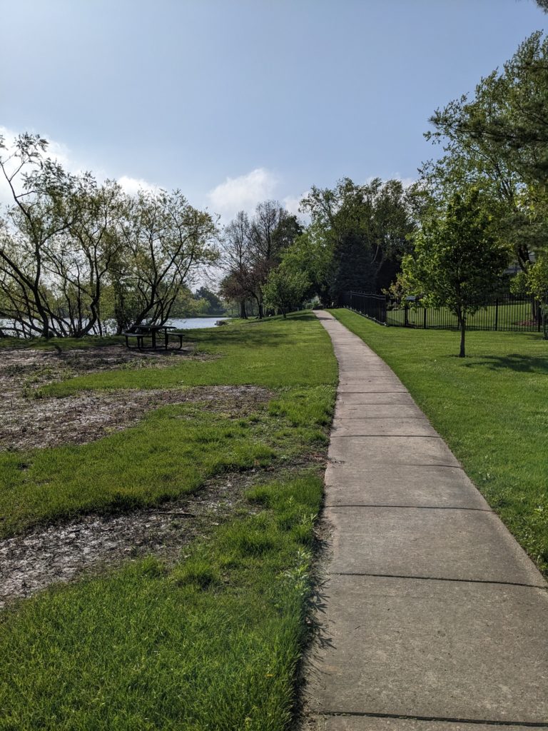 A rather flat paved footpath in suburban Savoy, Illinois.