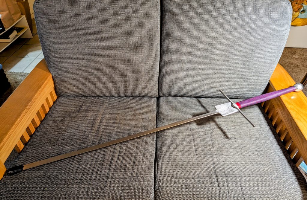 My longsword displayed on the loveseat. (It's longer than the loveseat is wide by several inches.)