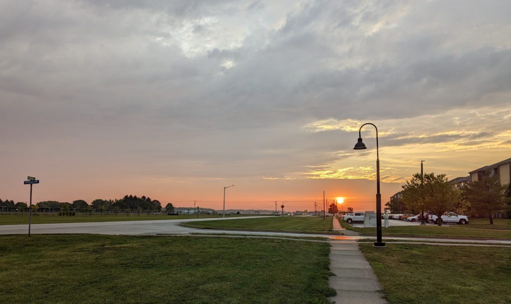 Sun rising due east over the sidewalk, the morning before the equinox