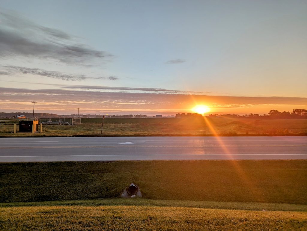 Sun on the horizon across First Street