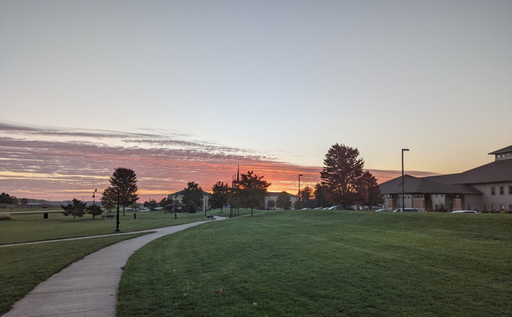 Dawn sky, but buildings block the view of the horizon