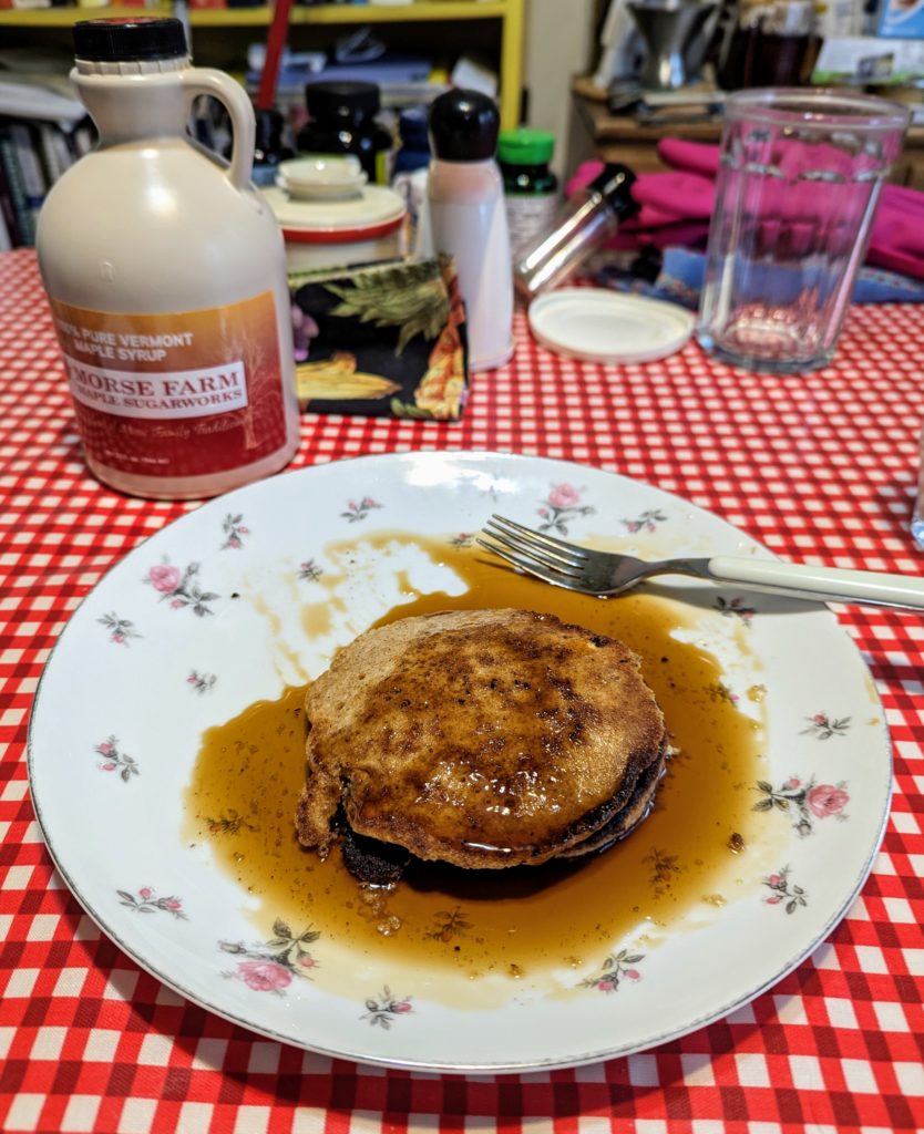 A stack of pancakes covered with maple syrup