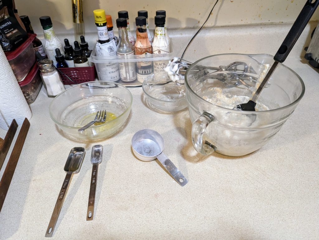 Pancake batter, and the bowls and measuring spoons used to make it.