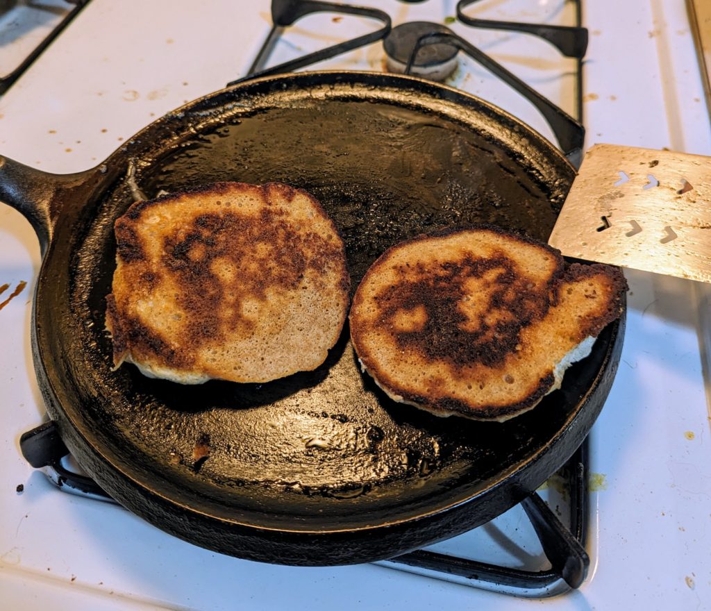Half-cooked pancakes on the griddle