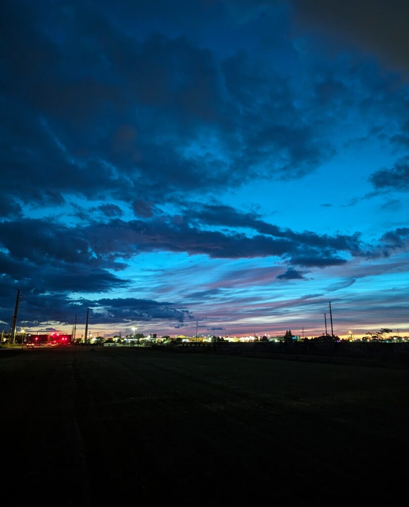 Post-sunset sky over the lights of a commercial district