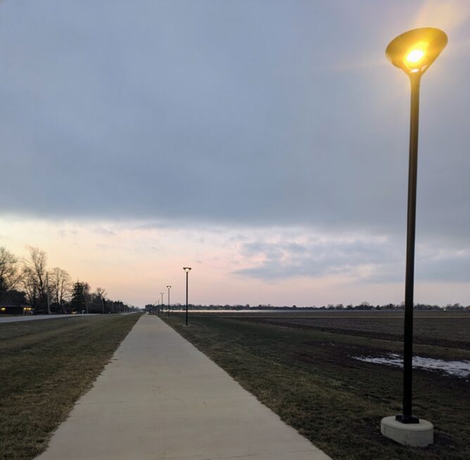 Looking south on the First Street path. The close lights are bright, and the further-away lights are dim