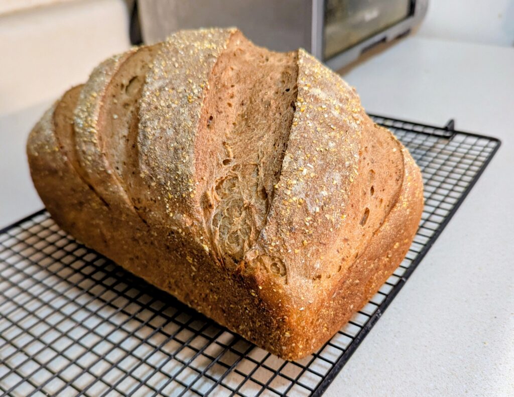 A loaf of freshly baked bread on a cooling rack